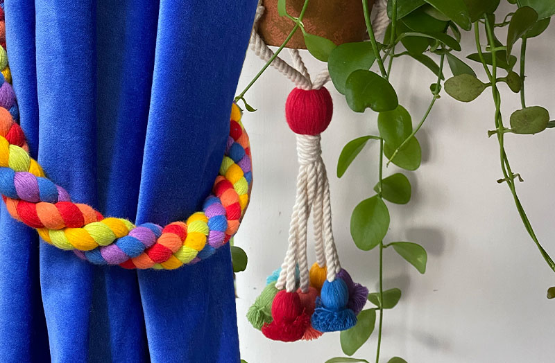 blue velvet curtains with multicolour tiebacks