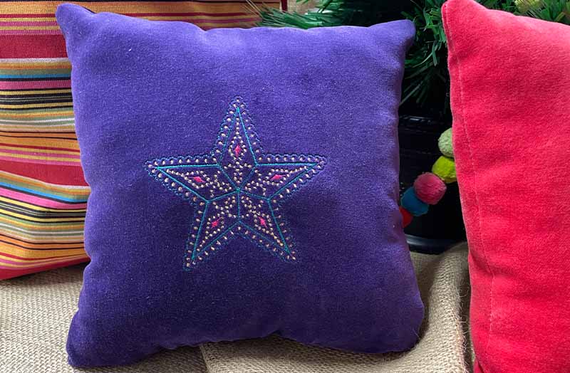 Christmas star embroidered velvet cushion