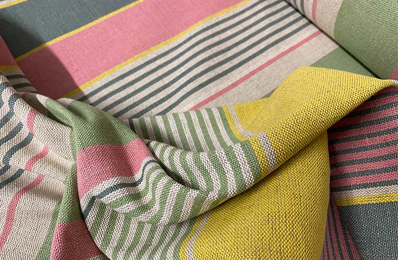 https://www.thestripescompany.us/images/product-images/striped-linen-fabric-yellow-pink-green-swirl.jpg